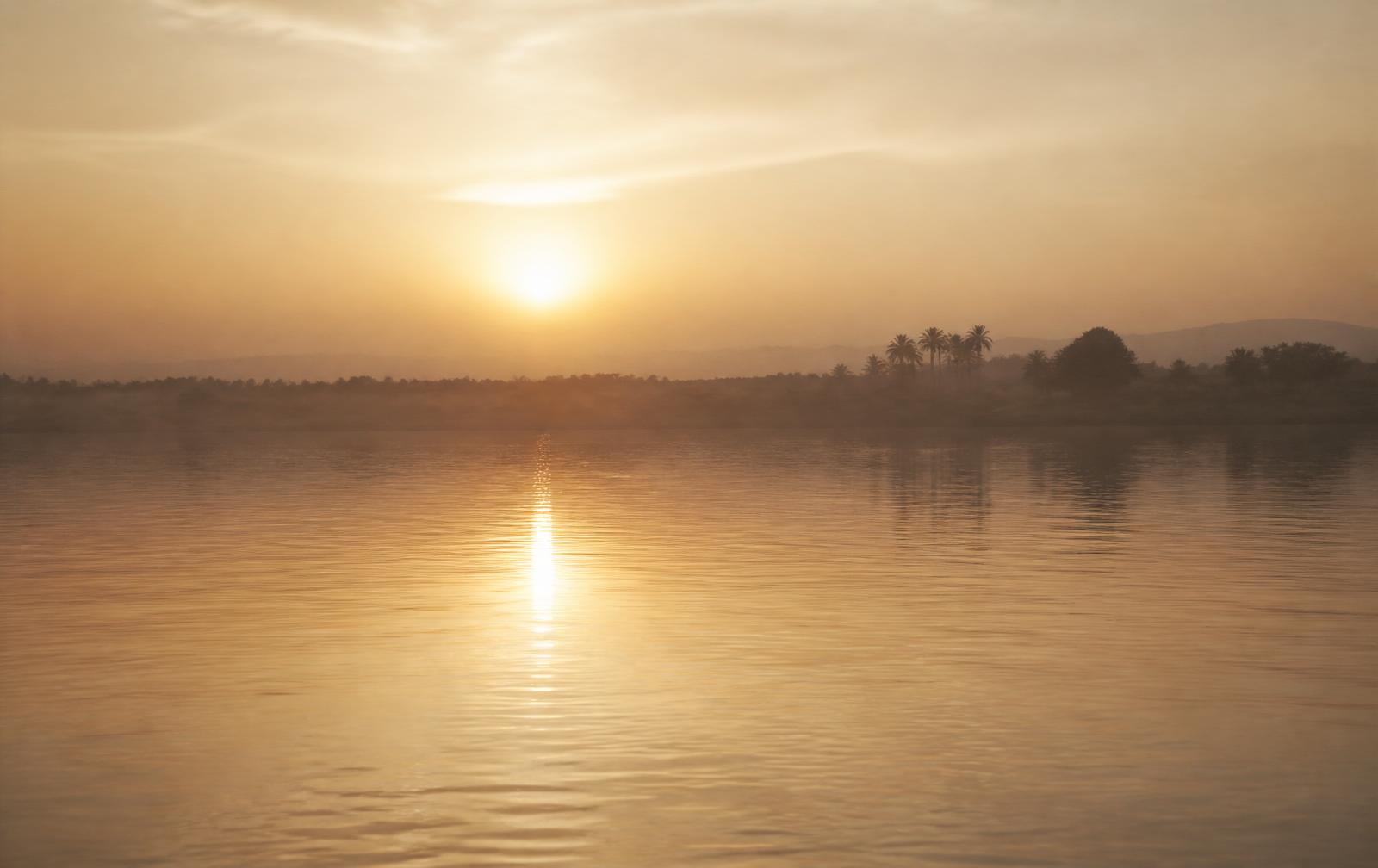 Golden dawn over still Nile water